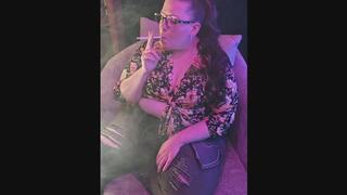 Sitting on my chaise in a flowered blouse and fashionably ripped jeans smoking a VS 120