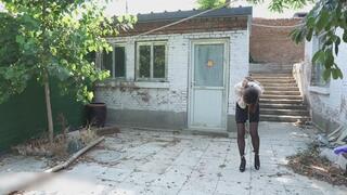 ly34-The girl was walking outdoors with her feet shackled.