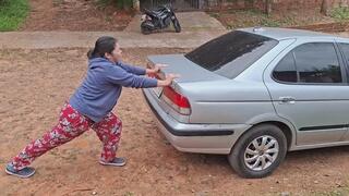 Jessie is trying to move and lift the broken-down car