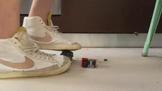 Old ruined Toy cars crushed under Nike blazer and fila disruptor sweaty sneakers