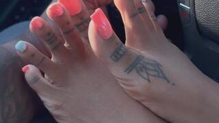 Massage your arm with her sexy feet as you drive