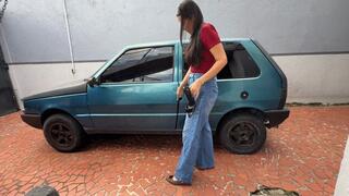 Kamila smokes while trying to start the Fiat 1. (Custom)
