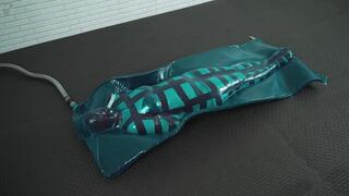 Hard bondage mummification tape corset in a blue latex vacuum trap