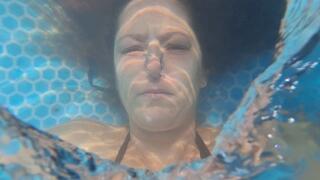 Underwater bubbles, and rings in black bikini and long hair