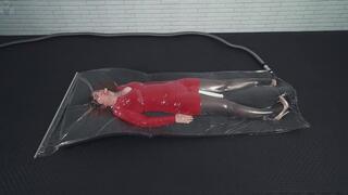 A girl in a red dress inside a thin vacuum bag on foam rubber a vibrator and an orgasm