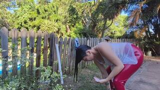 Washing my hair outdoors in shiny red leggings
