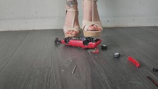 Giantess goddess Charlie Caroline Crushes a 1991 Pontiac Firebird in mega Wedges with painted toenails close ground view