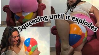 Small beach ball squeezing until it explodes