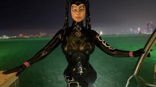 Rubbermissy in Full rubber enclosure with latexmask and Dorset having a Pool side cooldown in Dubai