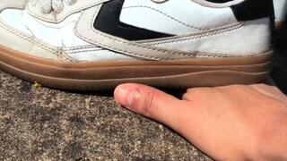 Woman crush My hand With old sneakers