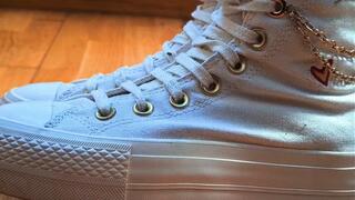 My girlfriend crushes my hand with her white Converse.