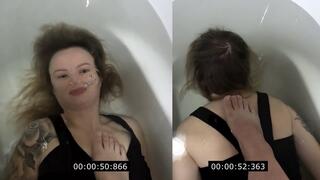 Anastasia is underwater with a foot on her