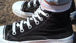 Woman in black Converse crushes my hand for money