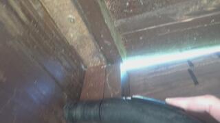 vacuuming spiders and cobwebs in a wooden toilet