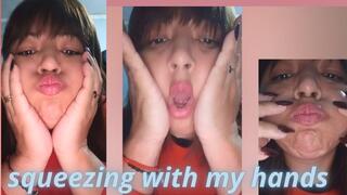 Squeezing my cheeks with my hands