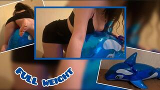 Mistress Mersiiik presses down with all her weight on the inflatable whale, sits on it, rubs, steps, stands on one leg, the whale is very heavy, sexy ass