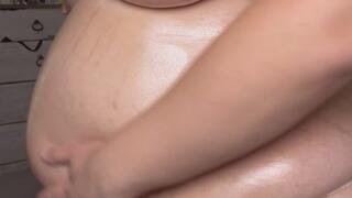 Huge pregnant belly body oil