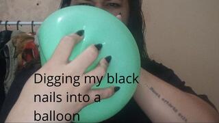 Digging my black nails into a balloon
