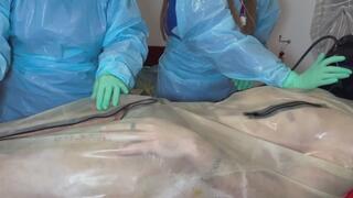 DOUBLE NURSES edge their rubber gimp wearing FULL PLASTIC PPE and minty coloured TIGHT latex gloves