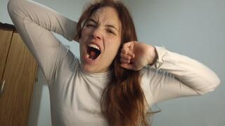 I yawn as I stretch, open my mouth and exhale, from a close-up