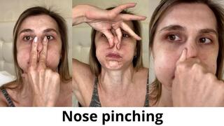 Puffing out cheeks, pinching nose, holding breath