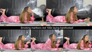 Smoking marlboro red 100s laying barefooted!