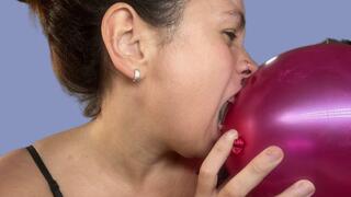 Biting a balloon and talking sexy
