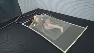 Sonya experiments with a vacuum bag inside a transparent latex vacuum bed
