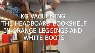 KG VACUUMING THE HEADBOARD BOOKSHELF IN ORANGE LEGGINGS AND WHITE BOOTS