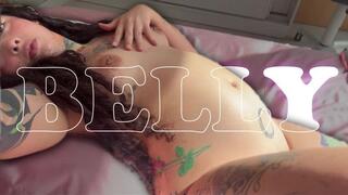 The tattooed girl shows you her big belly