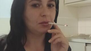 Brunette in black enjoying a cigarette