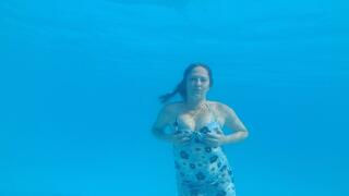 Swimming in Dress in a huge pool and blow bubbles