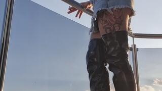 SEXY ON BALCONY SMOKER IN SKIRT DENIM & LEATHER BOOTS