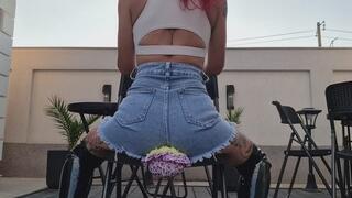 DENIM SKIRT GODDESS SQUASHING DOLL FACES & FARTS WITH LEATHER BOOTS.