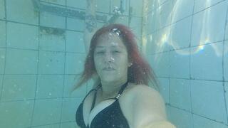 Going underwater in sexy black bikini and blowing bubbles