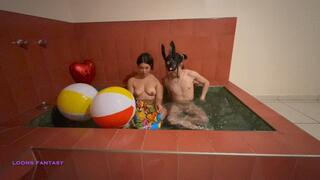 Duo blows up big beachballs on a jacuzzi