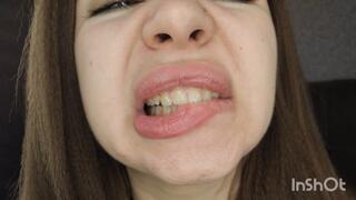 Demonstration of a wide mouth, deep throat, and sharp teeth