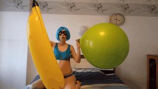 Irene inflates a balloon riding on a banana