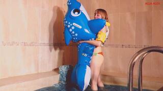 Alla blows off the blue inflatable whale in the pool and wears an inflatable vest!!!