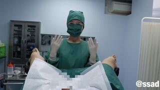 Nezumiko, an Asian, examined a patient's genitalia in a surgical gown