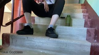 Dirty Vans shoe soles licking in tha public stairs