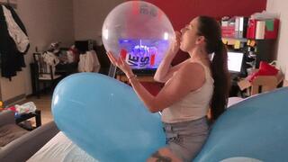 Sophie blows balloons and inflate to pop some