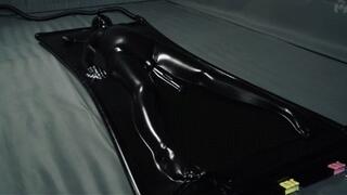 Orgasms in a black latex bed with a pear gag