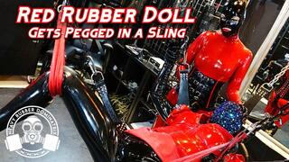 Red Rubber Doll Gets Pegged in Sling