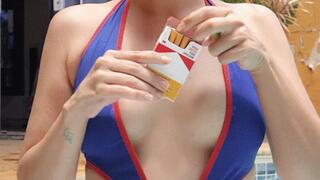 Naughty Smoking cork cigarette in a swimsuit by the pool