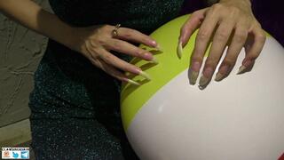 Nails scratching, puncture and destroying beach balls