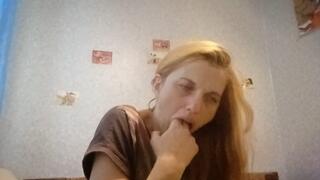 Old shabby woman induces vomiting