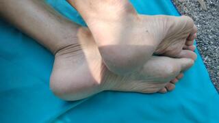 On a public beach, showing my worn feet, heels, toes and soles
