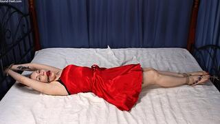 Ballgagged barefoot Amanda in red dress, bound on the bed with her hands tied to the headboard and with her feet tied to the footboard, is tickled by a man (HD WMV)