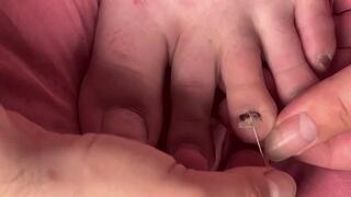 poking a fake fingernail with pins